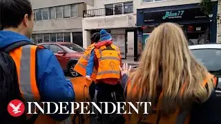 Moment motorist drives through Just Stop Oil protesters blocking road