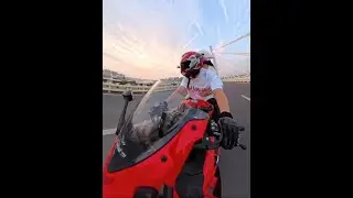 Riding motorcycle with loved one to watch sunset, romantic scenery.