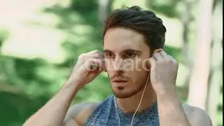 Sport Man Using Headphones for Listening Music on Morning Run in Park | Stock Footage - Envato e...