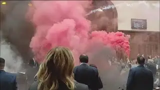 Serbian lawmakers throw smoke grenades and tear gas in protest