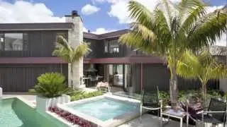 Small outdoor entertaining area accommodates a lap pool, spa pool, outdoor kitchen and fireplace