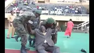 Uganda sports minister kicked a football and falls down