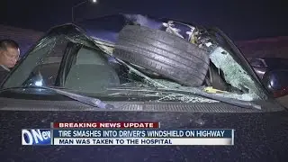 Loose tire flies through truck windshield on freeway, driver hurt