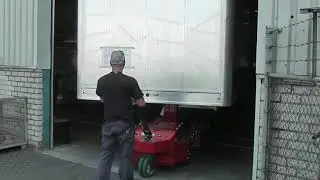 V-move xxl battery-powered walk-along semi trailermover pulling out a semi-trailer from a garage
