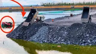 EP05!For the lake's development projects, 25-ton trucks are moving rocks, according to
