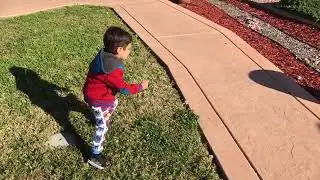 Little Kirk picking and blowing dandelions during our walk around our neighborhood.
