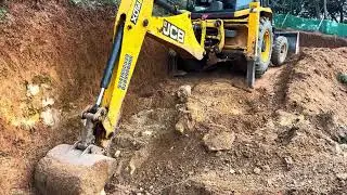 Jcb 3dx digging and moving soil for levelling land