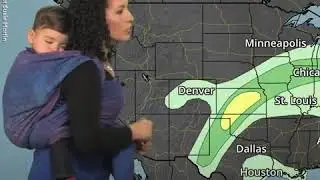 Meteorologist wears toddler son on her back during forecast