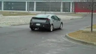GM CEO Ed Whitacre drives away in the Chevrolet Volt