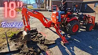Tractor Backhoe digs Asphalt and Blows a Tire Kioti CX2510