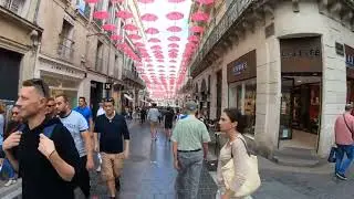 A Commercial Street Full Of People And Branded Stores