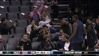 A kid who received Anthony Edwards jersey fist bumping everyone on his way back to his seat