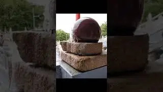 Slow motion of a rotating Giant Granite Ball