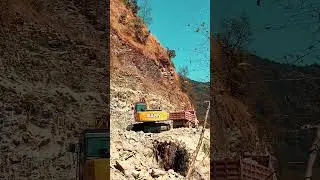 Excavator Loading Dump Trucks, Collecting stones for road construction