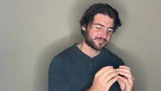 Squirting condiments on a sandwich and eating it