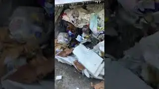 Garbage truck after heavy rain trying to pack water