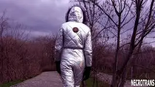 Modern panoramic gas mask CM-6 and ski overalls with a hood in an amalgam iridescent silver color