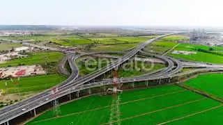 High Voltage Electricity Tower and Power Lines Near Multi-Level Highway Intersection | Stock Foo...