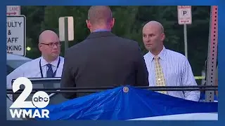 Police investigate a dead body found in the parking lot of Pikesville High School