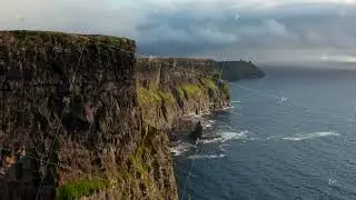 Forwards fly along amazing scenic cliffs. High vertical rock walls falling into rippled water