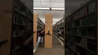 Girls are running through the library bookshelves before they close!