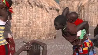 El Molo Village, woman carrying child joins the group, UHD 4K
