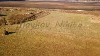 The tractor plows a field with fertilizers. Autumn, Russia, From Dron