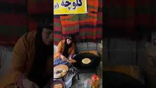 Local women make traditional pies outside Quri Qala Cave in Iran
