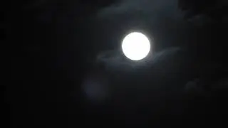 The Snow Moon with Clouds Passing and Changing Exposure Settings