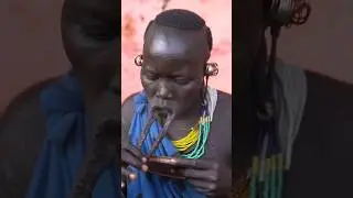 Woman from Surma tribe inserts lip plate | Omo Valley Ethiopia #shorts