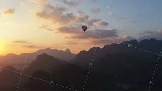 Hot air balloons flying over Vang Vieng town in Laos with karst mountains background during scenic