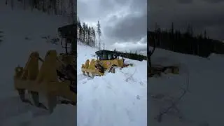 Clearing spring snow off logging roads with a Cat D7 and WBM pioneering blade