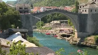 People swim under Mostar bridge as Bosnia feels new heat wave, Miljacka river left dried up