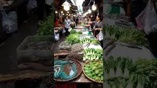 Busy Traditional Asian Market Stall with Exotic Animals and Fresh Vegetables