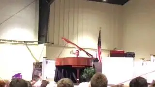 Pastor Kenny Baldwin sings, 