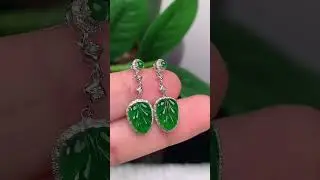 Jade earrings with intricate gold branches and jade leaves, finely crafted.