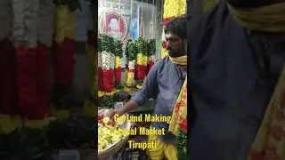 Garland making at local flower market South India