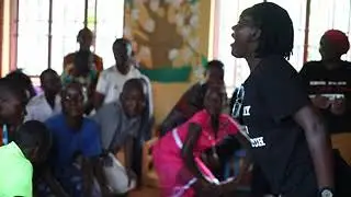 Fairplay off pitch executive Tr. Milley singing for all the birthday babies at PDI Academy Bududa
