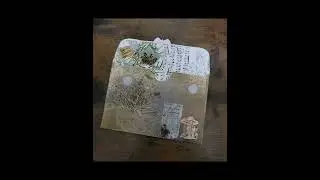 Altered envelope using many Tim Holtz products.