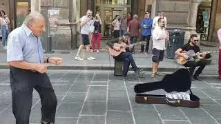 Elderly Man Dances as Street Musicians Perform in Italy - 1051575