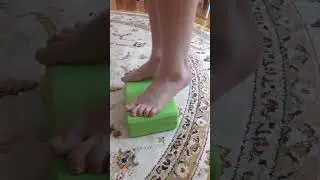 Foot strengthening exercises on a small block for kids, designed to prevent flat feet.
