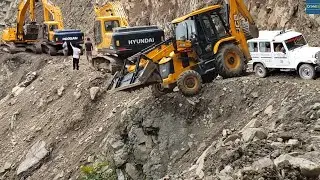 Excavators & Backhoes Open Mountain Road: Clearing the Way for Waiting Vehicles
