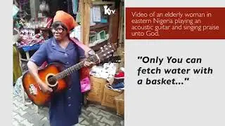 Elderly Lady Singing and Playing Guitar