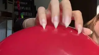 Long, natural nails popping balloons