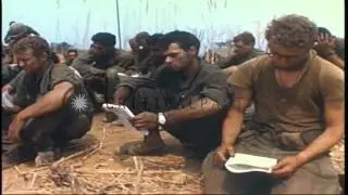 A catholic chaplain conducts the Mass and soldiers receive communion in Vietnam. HD Stock Footage