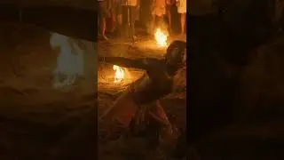 Amidst a circle of fire, a man is seen in a trance-like state, embodying t spirits#ritual#firecircle