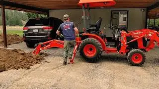 Kubota B2301 & BH70 backhoe digging in a french drain.