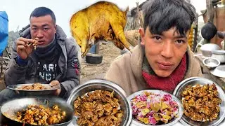 Eating meat after slaughtering a male goat in the pasture shed.
