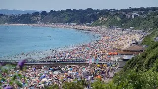 UK heatwave: Summer revellers flock to Bournemouth beach to enjoy the sun