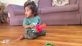 Kid playing with Sassy Stacks Circles Toys